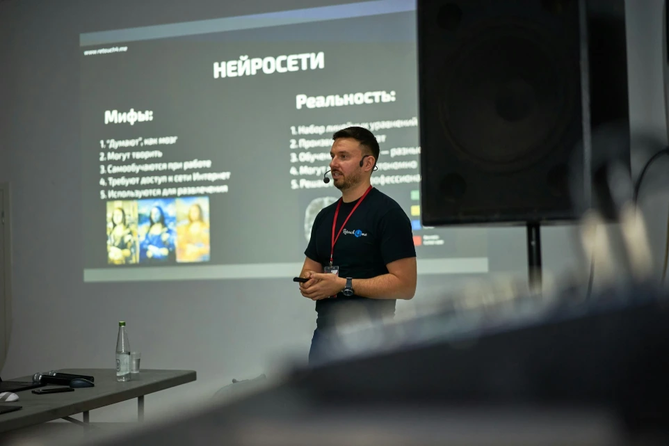 A man standing in front of a projector screen